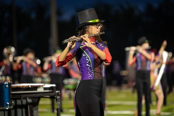 Ravenwood High band members march